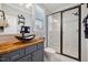 Modern bathroom featuring a glass enclosed shower, wood countertop with vessel sink, and stylish fixtures at 221 Obsidian Dr, Holly Springs, NC 27540