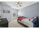 Bedroom featuring a bed, ceiling fan, and window for natural lighting and comfort at 221 Obsidian Dr, Holly Springs, NC 27540