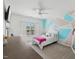 Bedroom featuring a bed, ceiling fan, and large window for natural lighting and relaxation at 221 Obsidian Dr, Holly Springs, NC 27540