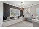 Bonus room with a gray accent wall, window seat, chandelier, and neutral carpet at 221 Obsidian Dr, Holly Springs, NC 27540