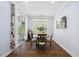 Bright dining area with hardwood floors, modern lighting, and sliding glass doors to the outside at 221 Obsidian Dr, Holly Springs, NC 27540