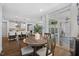 Open-concept dining area that overlooks kitchen with a decorative vase as the centerpiece on a wood table at 221 Obsidian Dr, Holly Springs, NC 27540