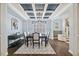 Elegant dining room showcasing a coffered ceiling, stylish chandelier, and hardwood flooring at 221 Obsidian Dr, Holly Springs, NC 27540