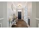 Foyer featuring a hardwood floor, decorative table, and natural lighting at 221 Obsidian Dr, Holly Springs, NC 27540