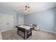 Spacious game room with air hockey table, furniture, ceiling fan and window views at 221 Obsidian Dr, Holly Springs, NC 27540
