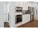 Close-up of stainless steel appliances, including double ovens, a microwave, and refrigerator, set in custom cabinetry at 221 Obsidian Dr, Holly Springs, NC 27540