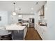 Gourmet kitchen features custom white cabinetry and an island with barstool seating at 221 Obsidian Dr, Holly Springs, NC 27540
