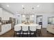Modern kitchen with white cabinets, a large island with seating, stainless steel appliances, and an open floor plan at 221 Obsidian Dr, Holly Springs, NC 27540