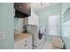 Functional laundry room with built-in cabinets, countertop and laundry basket at 221 Obsidian Dr, Holly Springs, NC 27540
