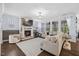 Bright living room with a stone fireplace, recessed lighting, and a cozy armchair at 221 Obsidian Dr, Holly Springs, NC 27540