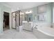 Bright main bathroom featuring soaking tub, walk-in closet, double vanity and shower at 221 Obsidian Dr, Holly Springs, NC 27540