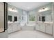 Bright main bathroom featuring soaking tub, walk-in closet, double vanity and shower at 221 Obsidian Dr, Holly Springs, NC 27540