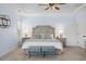 Main bedroom features a tray ceiling, wainscoting, carpet, and an upholstered king-size bed at 221 Obsidian Dr, Holly Springs, NC 27540