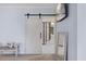 Spacious main bedroom with barn door leading into ensuite bathroom at 221 Obsidian Dr, Holly Springs, NC 27540