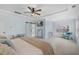 Spacious main bedroom with tray ceilings, ceiling fan and barn door leading into ensuite bathroom at 221 Obsidian Dr, Holly Springs, NC 27540