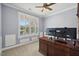 Home office featuring a large desk, ample natural light, and neutral walls at 221 Obsidian Dr, Holly Springs, NC 27540