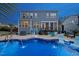 Backyard pool with fountains, in-pool seating and view of the home's exterior at 221 Obsidian Dr, Holly Springs, NC 27540