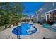 Beautiful backyard pool with in-pool seating, lights, and lush landscaping at 221 Obsidian Dr, Holly Springs, NC 27540