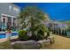 Backyard pool with rock accents and lush landscaping, creating a serene and inviting outdoor space at 221 Obsidian Dr, Holly Springs, NC 27540
