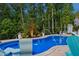 Sparkling pool featuring fountain features, in-pool seating and professional landscaping at 221 Obsidian Dr, Holly Springs, NC 27540