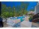Inviting backyard pool area with seating, outdoor rug, and tasteful landscaping at 221 Obsidian Dr, Holly Springs, NC 27540