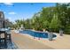 Backyard featuring an in-ground pool, trees, plants and lounge furniture for outdoor leisure at 221 Obsidian Dr, Holly Springs, NC 27540