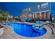 Backyard pool featuring sunbathing chairs and patio, set against a two-story home at 221 Obsidian Dr, Holly Springs, NC 27540