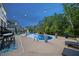 Inviting backyard pool with lights, in-pool seating, and patio area at 221 Obsidian Dr, Holly Springs, NC 27540