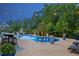 Backyard pool with lighting, water feature and beautifully maintained greenery at 221 Obsidian Dr, Holly Springs, NC 27540