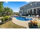 Stunning backyard pool area surrounded by lush landscaping and a comfortable patio space at 221 Obsidian Dr, Holly Springs, NC 27540