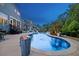 Beautiful backyard pool with fountains, fire pits and a well maintained patio at 221 Obsidian Dr, Holly Springs, NC 27540