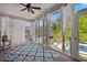 Sunroom with large windows, ceiling fan, and blue patterned rug with access to a pool at 221 Obsidian Dr, Holly Springs, NC 27540