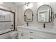 Bathroom boasting a double sink vanity, large mirrors, and a combined shower and tub at 2405 Pearces Rd, Zebulon, NC 27597