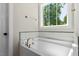 Bathroom showcasing a large soaking tub and a window with a view at 2405 Pearces Rd, Zebulon, NC 27597