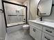 Updated bathroom with white cabinets, marble floors, and tiled shower at 2405 Pearces Rd, Zebulon, NC 27597