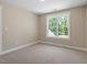 Comfortable bedroom with large window and neutral-toned carpet at 2405 Pearces Rd, Zebulon, NC 27597