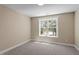 Comfortable bedroom featuring a large window and carpeted flooring at 2405 Pearces Rd, Zebulon, NC 27597