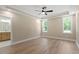 Spacious bedroom featuring tray ceilings, a ceiling fan, and large windows at 2405 Pearces Rd, Zebulon, NC 27597
