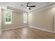 Bedroom showcasing tray ceilings, a ceiling fan and a large window at 2405 Pearces Rd, Zebulon, NC 27597