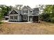 Beautiful two-story home with gray siding, black shutters, stone accents, and a well-manicured lawn at 2405 Pearces Rd, Zebulon, NC 27597