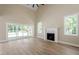 Bright living room with hardwood floors, fireplace, and sliding doors to outdoor space at 2405 Pearces Rd, Zebulon, NC 27597