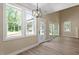 Bright, airy living room open to the outside, featuring sleek flooring, a cozy fireplace and large windows for abundant natural light at 2405 Pearces Rd, Zebulon, NC 27597