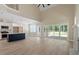 Expansive living area with a fireplace, open to the kitchen, featuring large sliding doors that bring the outdoors in at 2405 Pearces Rd, Zebulon, NC 27597