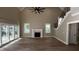 Open living room with hardwood floors, fireplace, high ceilings, and a staircase at 2405 Pearces Rd, Zebulon, NC 27597