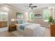 Serene main bedroom with a ceiling fan, tray ceiling, and ensuite bathroom access at 2405 Pearces Rd, Zebulon, NC 27597