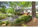 Beautiful backyard with a screened porch, patio, lush landscaping, and an outdoor dining area at 2481 Foxwood Dr, Chapel Hill, NC 27514