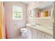 Charming pink bathroom featuring wainscoting and natural light from the window at 2481 Foxwood Dr, Chapel Hill, NC 27514