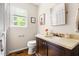 This bathroom features a marble vanity, a stylish mirror, and a window providing natural light at 2481 Foxwood Dr, Chapel Hill, NC 27514
