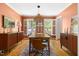 Stylish dining room featuring warm colors, modern lighting, and classic shuttered windows at 2481 Foxwood Dr, Chapel Hill, NC 27514