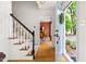 Inviting entryway with hardwood floors, staircase, and a view into the dining room at 2481 Foxwood Dr, Chapel Hill, NC 27514